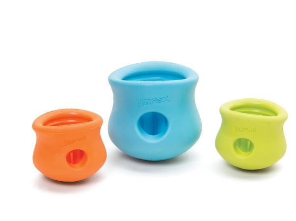 3 different coloured "Toppl". Cups with a hole in the side that deposit treats when played with by a dog. There is a large light blue Toppl in the middle and two smaller Toppl, one on either side. Left is orange and right is a lime green.
